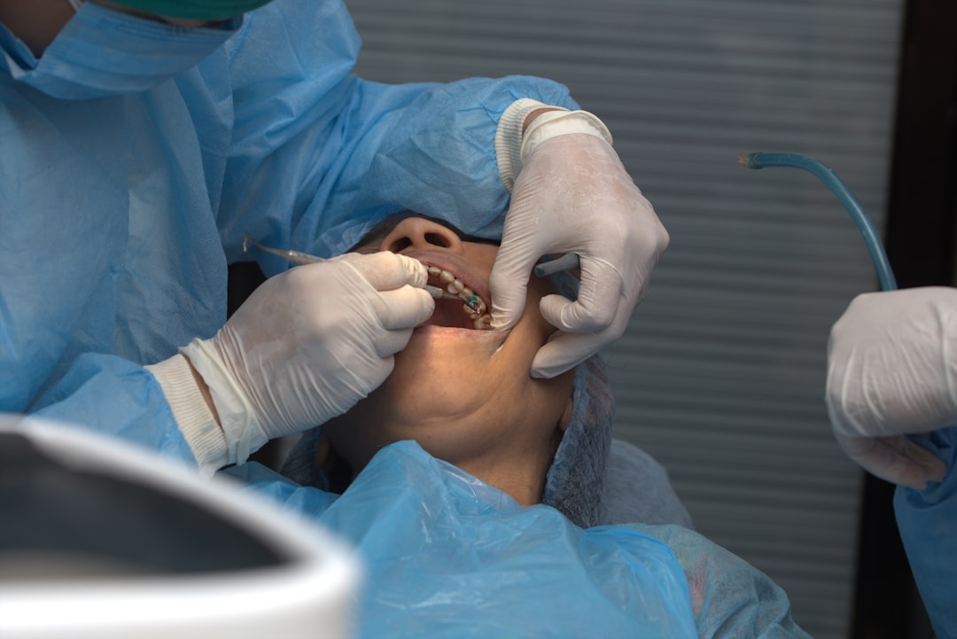 Dentist examining a patient's gums during a periodontal evaluation in Berkeley