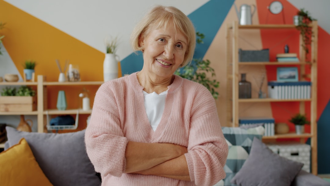 Older woman with a confident, natural-looking smile years after porcelain veneer placement